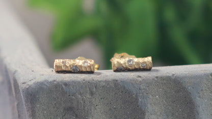 Solid 14k gold bar studs, textured and set with 3 diamonds in each.