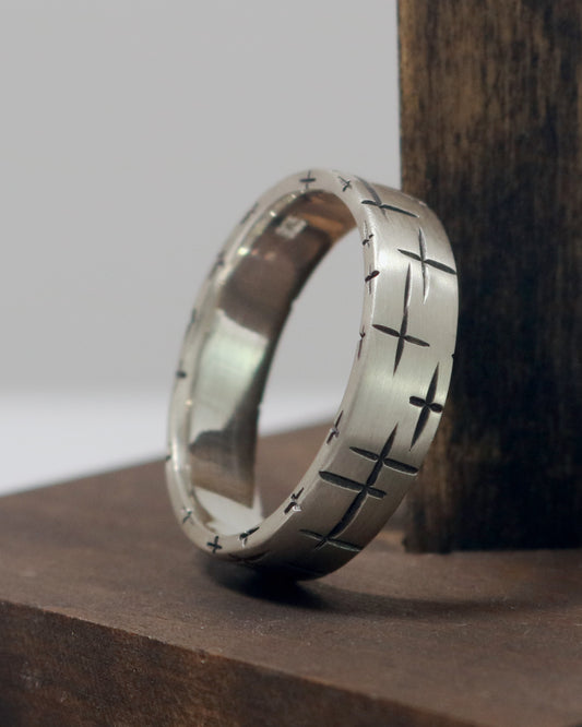 Black cross hatch marks all around this 6mm sterling silver ring band.