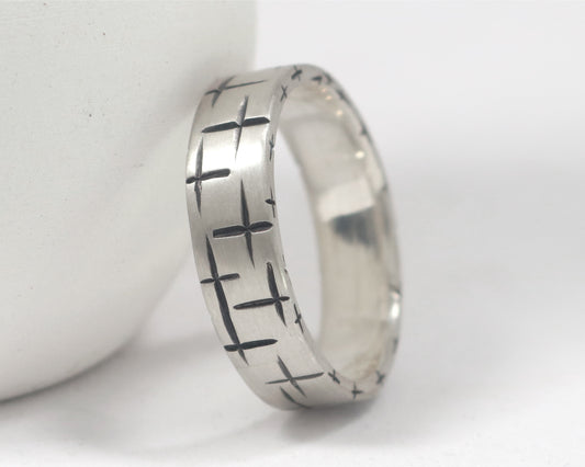Black cross hatch marks all around this 6mm sterling silver ring band.