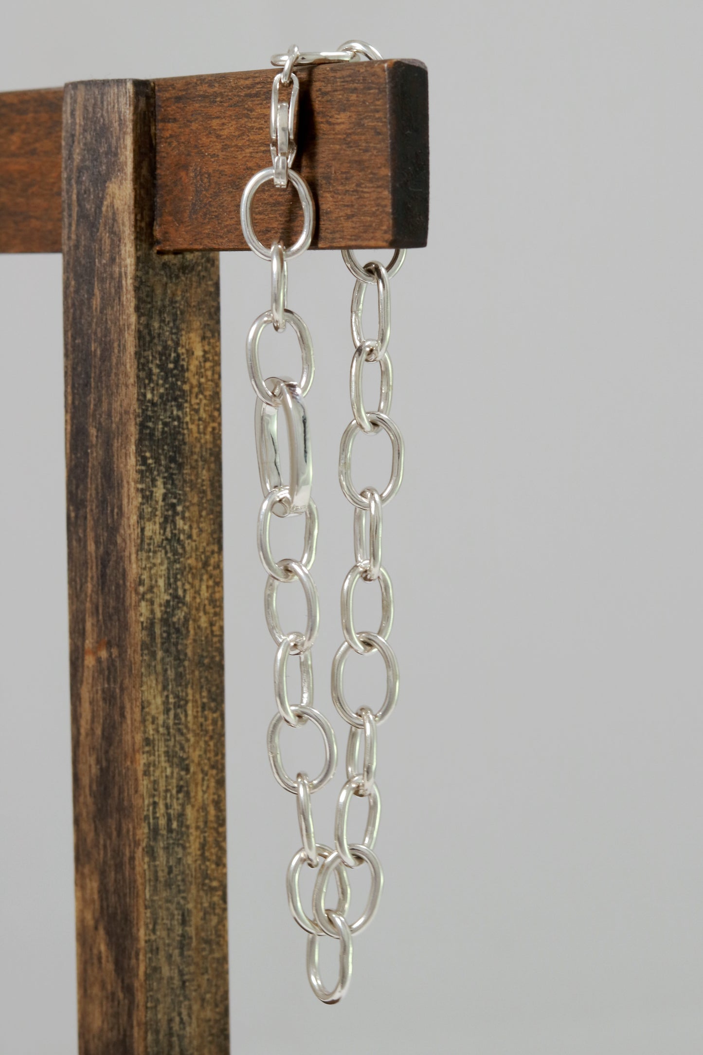 Sterling silver oval link bracelet with one thick oval link.