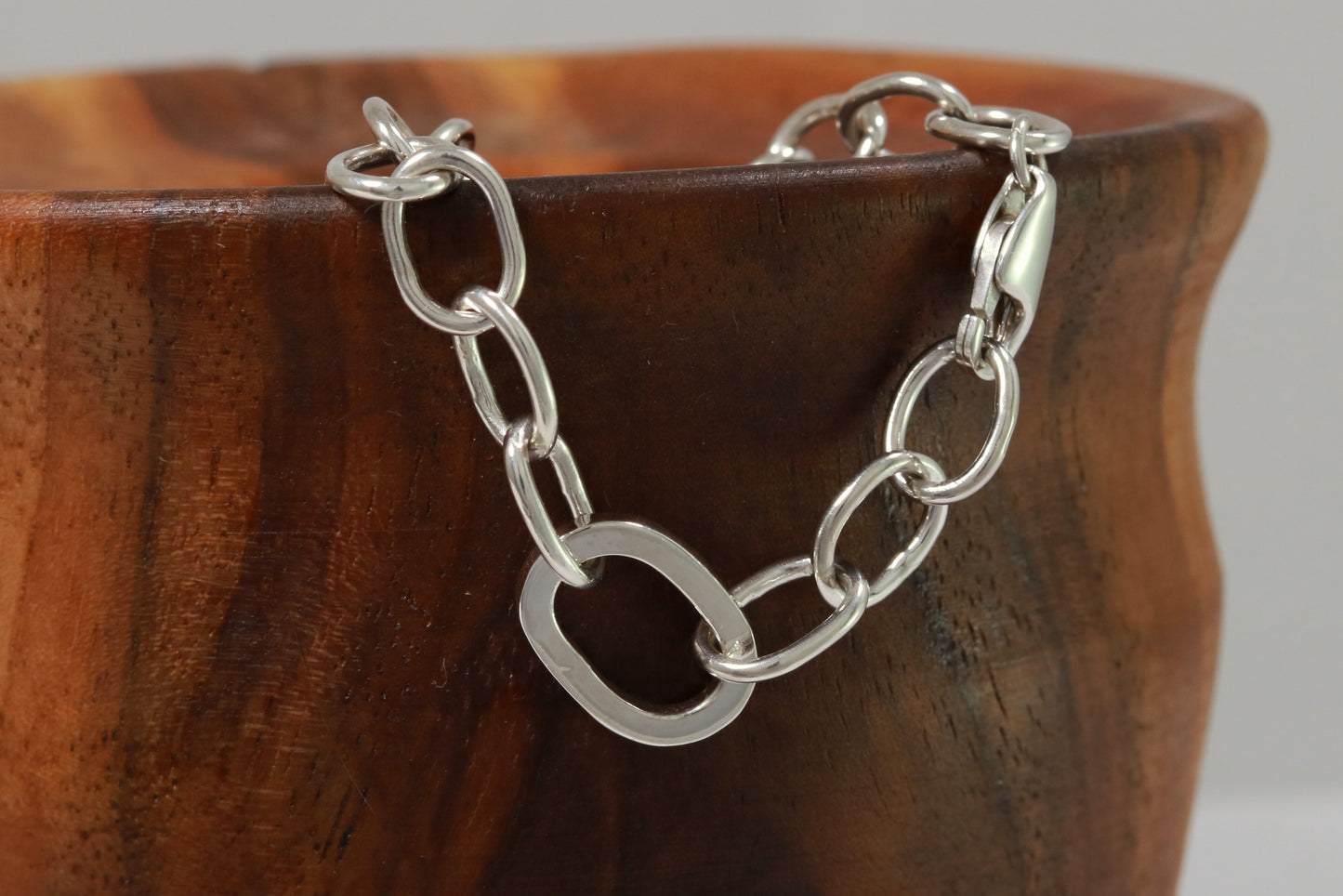 Sterling silver oval link bracelet with one thick oval link.