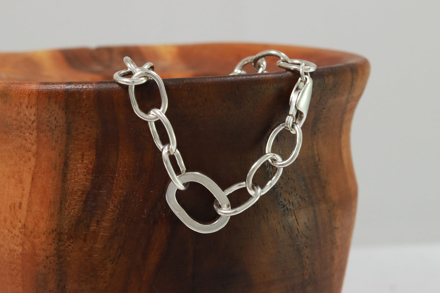 Sterling silver oval link bracelet with one thick oval link.