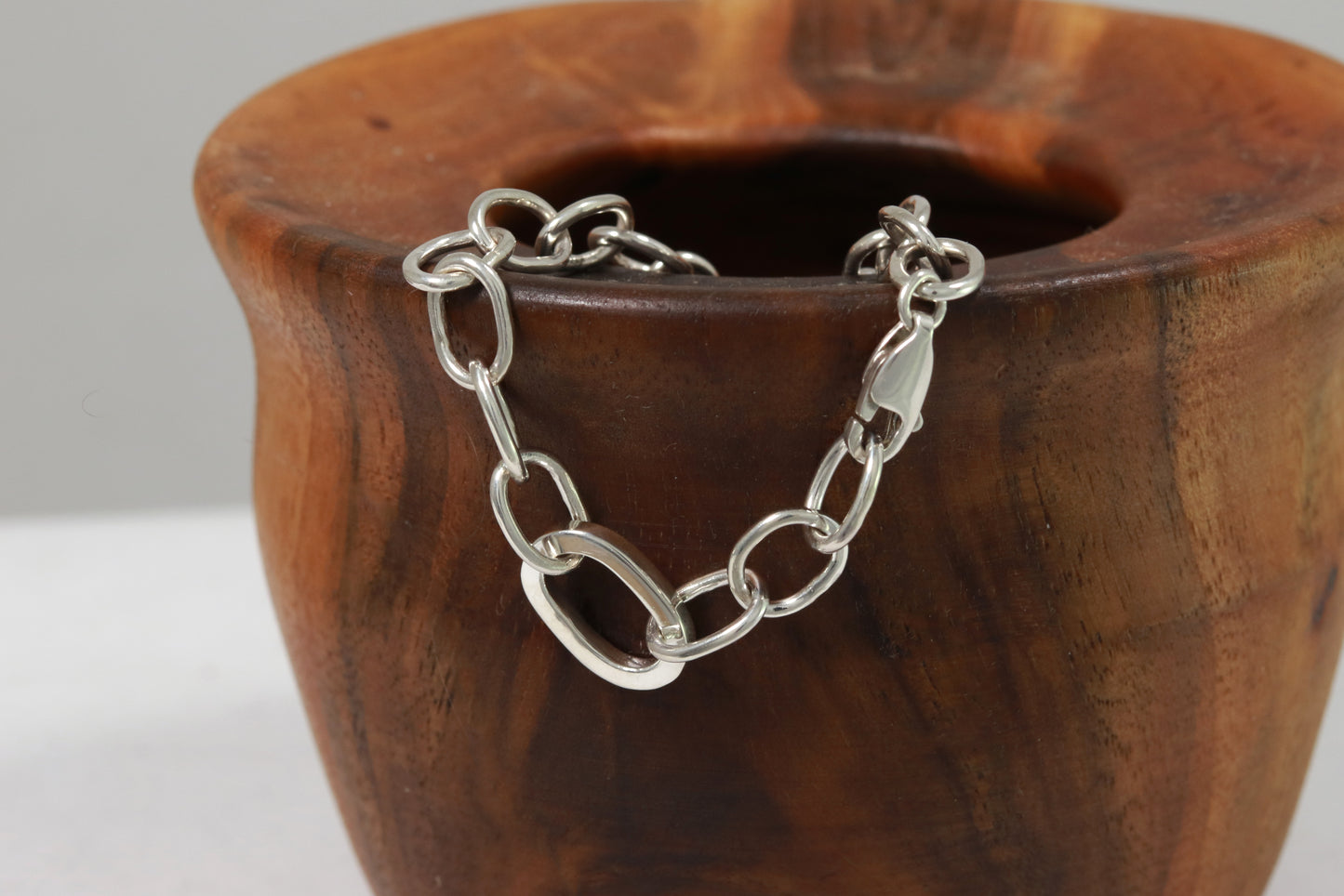 Sterling silver oval link bracelet with one thick oval link.