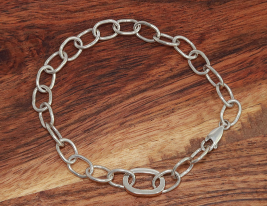 Sterling silver oval link bracelet with one thick oval link.