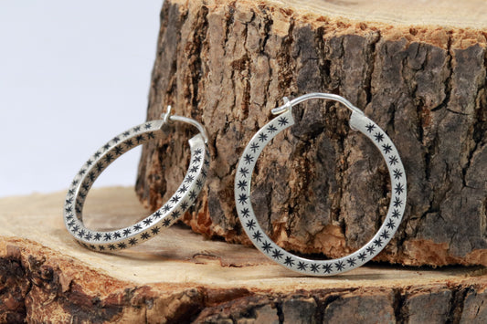 Closing hoops made from 2mm x 2mm square sterling silver, hand cut black stars on all sides. 