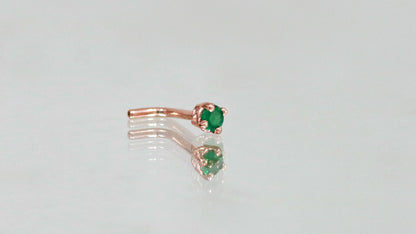 A basket set, round,  faceted emerald nose stud made from 14k yellow gold.