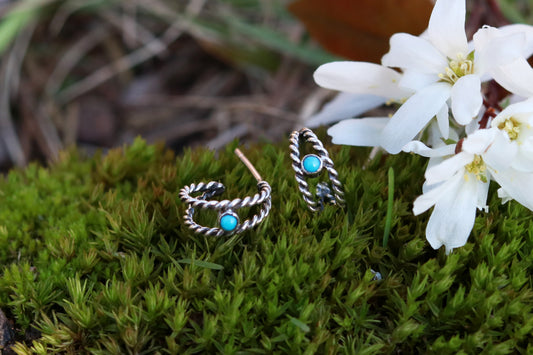 Small hoop huggie earrings made from 2 twisted sterling silver hoops with a round natural gemstone.