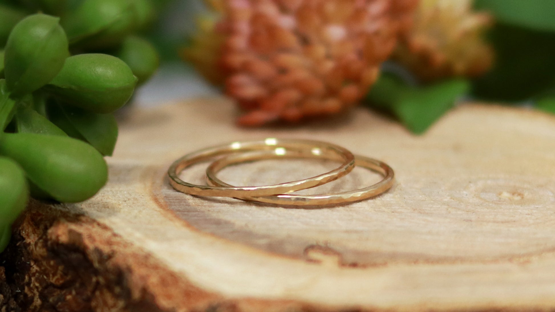 Thin yellow gold stacking rings with a hammer texture.