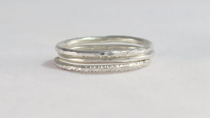 Thin sterling silver stacking rings with a hammer texture.