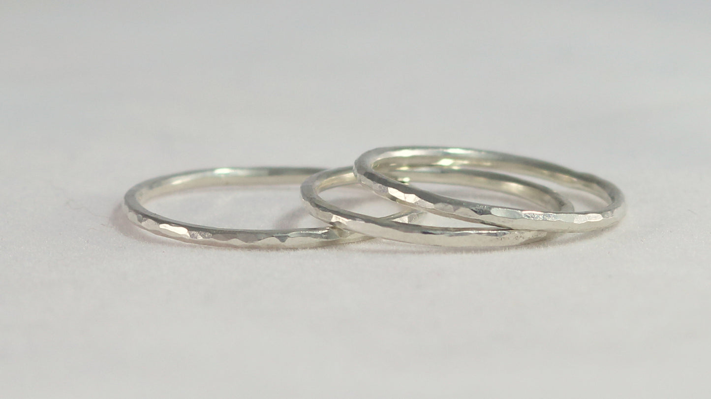 Thin sterling silver stacking rings with a hammer texture.