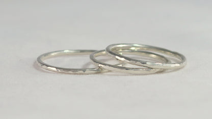 Thin sterling silver stacking rings with a hammer texture.