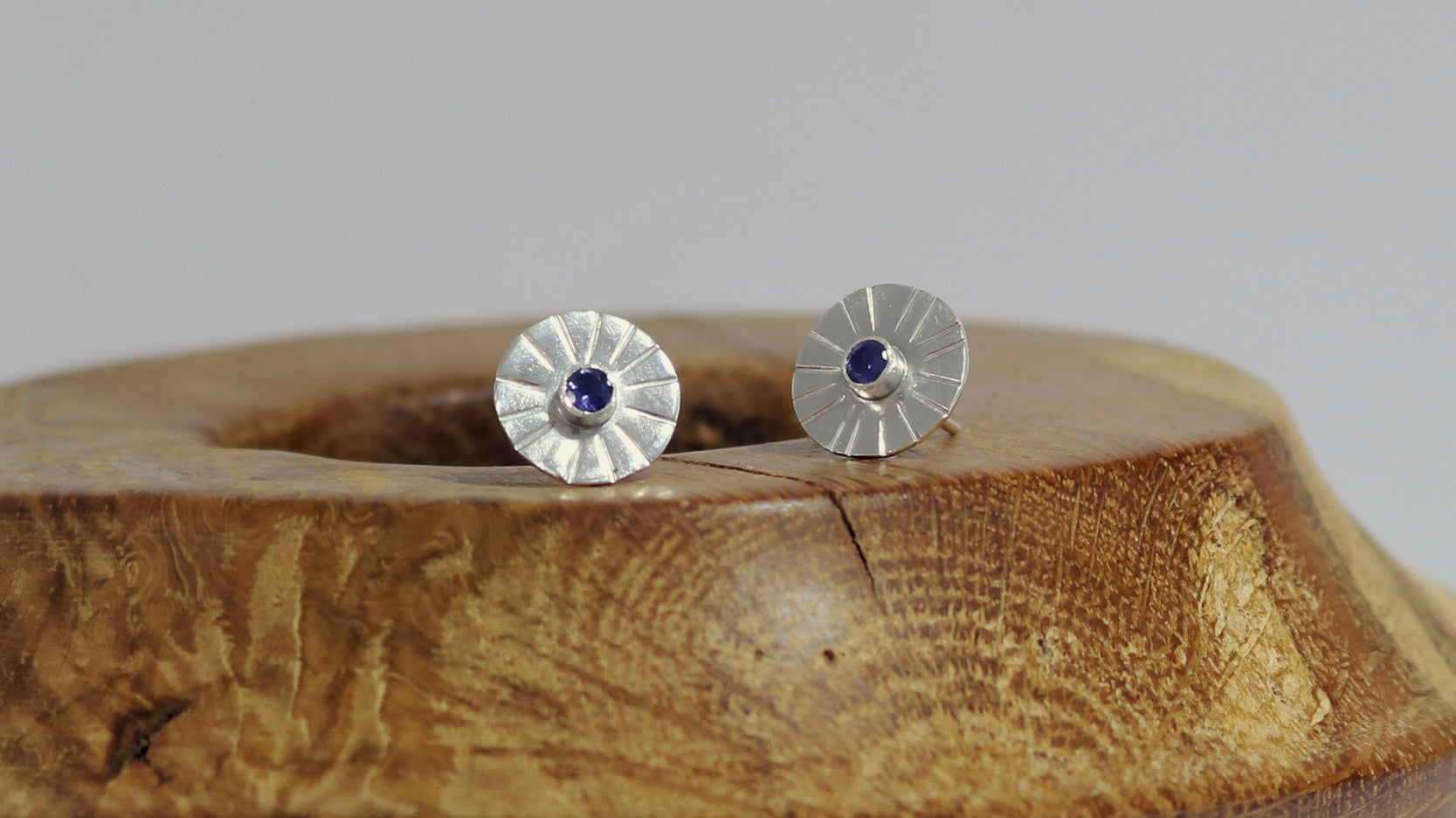 Sterling silver disc stud earrings with a natural round gemstone that has sunburst lines.