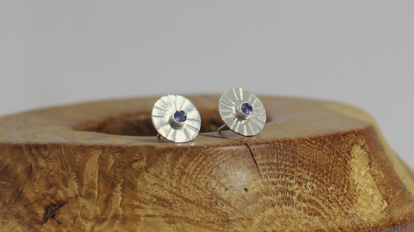 Sterling silver disc stud earrings with a natural round gemstone that has sunburst lines.