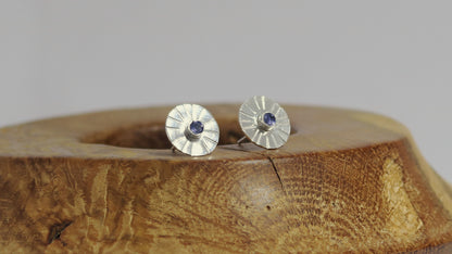 Sterling silver disc stud earrings with a natural round gemstone that has sunburst lines.