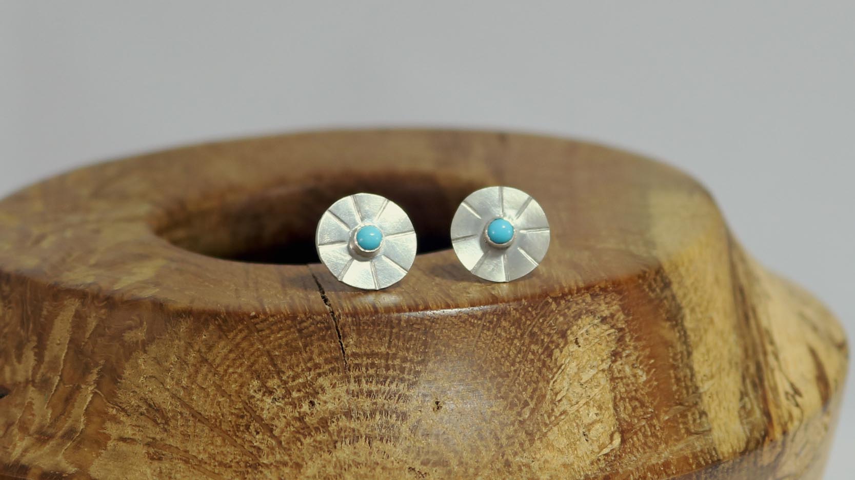 Sterling silver disc stud earrings with a natural round gemstone that has sunburst lines.