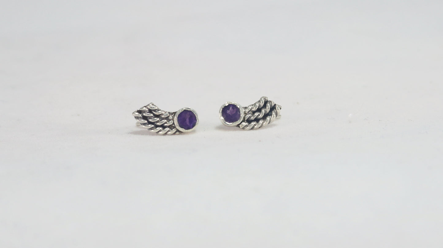 Stud earrings, round natural gemstones set in sterling silver bezels with silver, curved twisted tails meant to be worn two ways. 