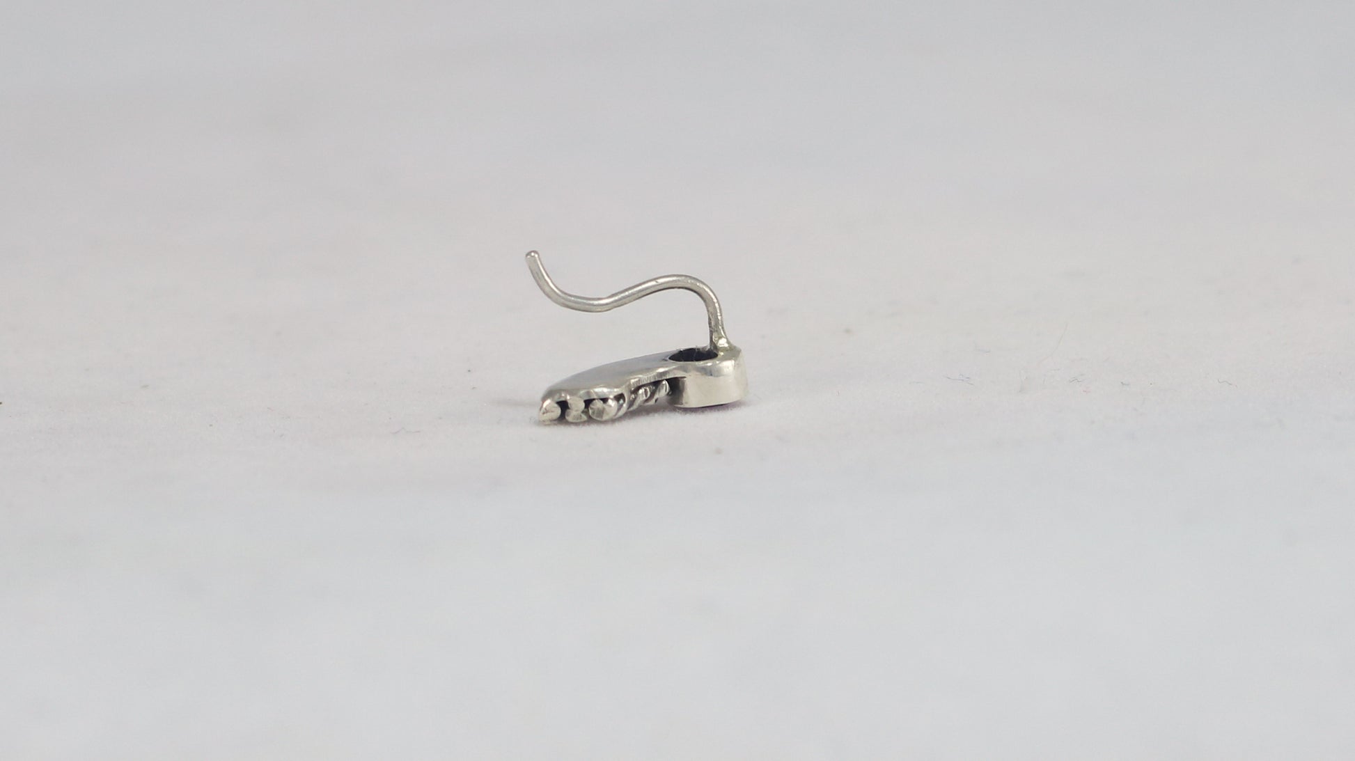 Stud earrings, round natural gemstones set in sterling silver bezels with silver, curved twisted tails meant to be worn two ways. 