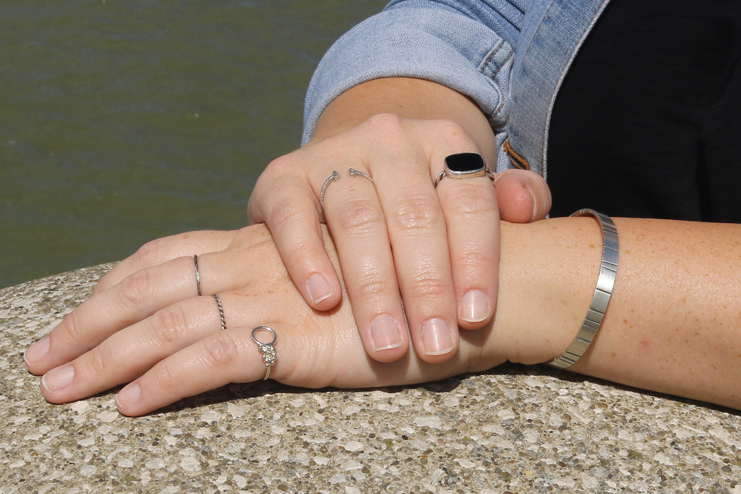 A model wearing Thin sterling silver stacking rings with a hammer texture.