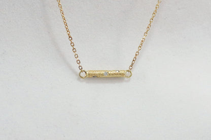 Solid 14k gold bar necklace, textured and set with 6 diamonds.