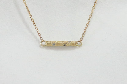 Solid 14k gold bar necklace, textured and set with 6 diamonds.