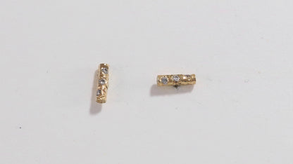 Solid 14k gold bar studs, textured and set with 3 diamonds in each.