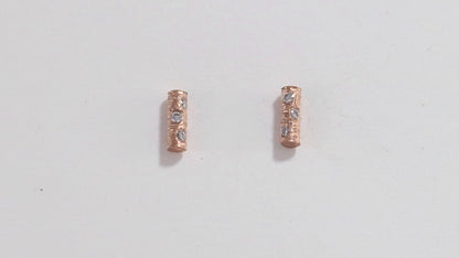 Solid 14k gold bar studs, textured and set with 3 diamonds in each.