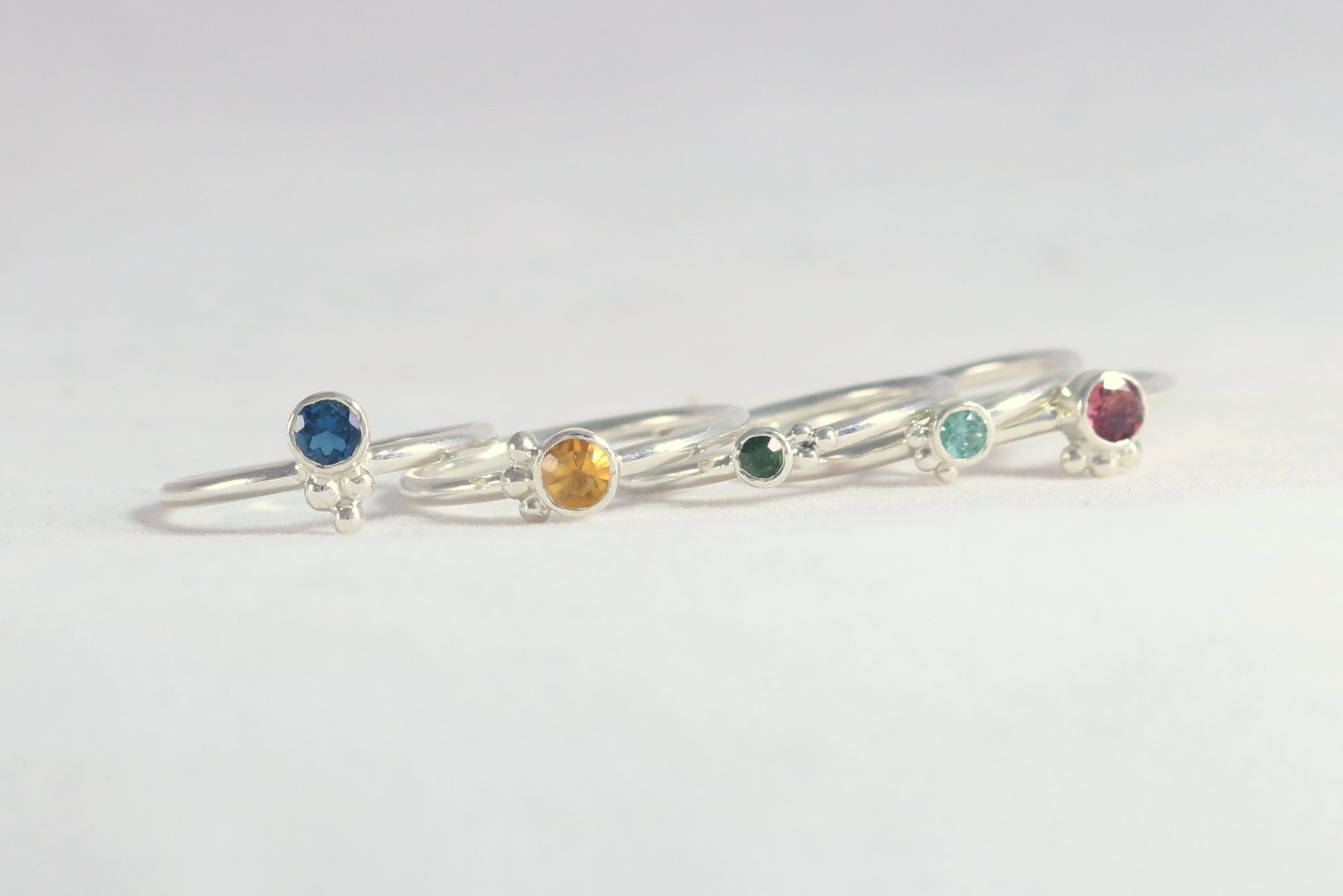 Natural gemstone set in sterling silver bezel, silver bubble pyramid accents on sterling silver ring band.