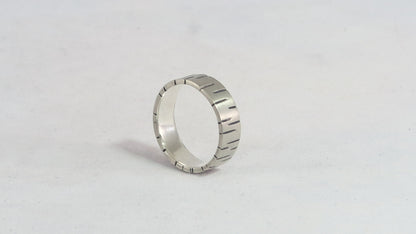 6mm sterling silver ring band with offset, randomly spaced, black lines.