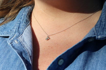 Three sterling silver bubbles in a pyramid on a sterling silver chain.