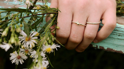 A thick sterling silver ring band with a rough hammer texture. 