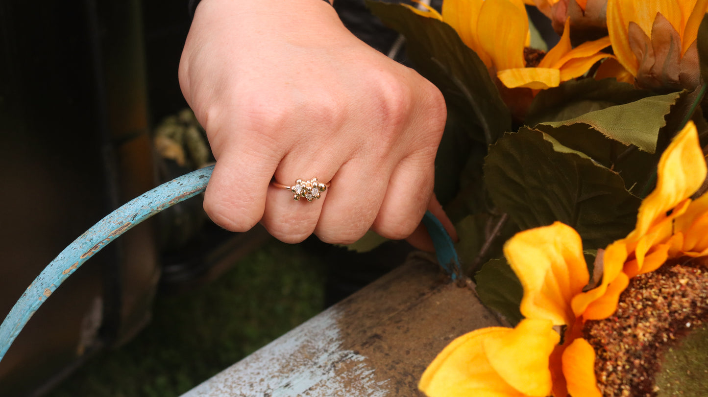 14k yellow gold bubble cluster ring with three 2mm white diamonds being modeled. 