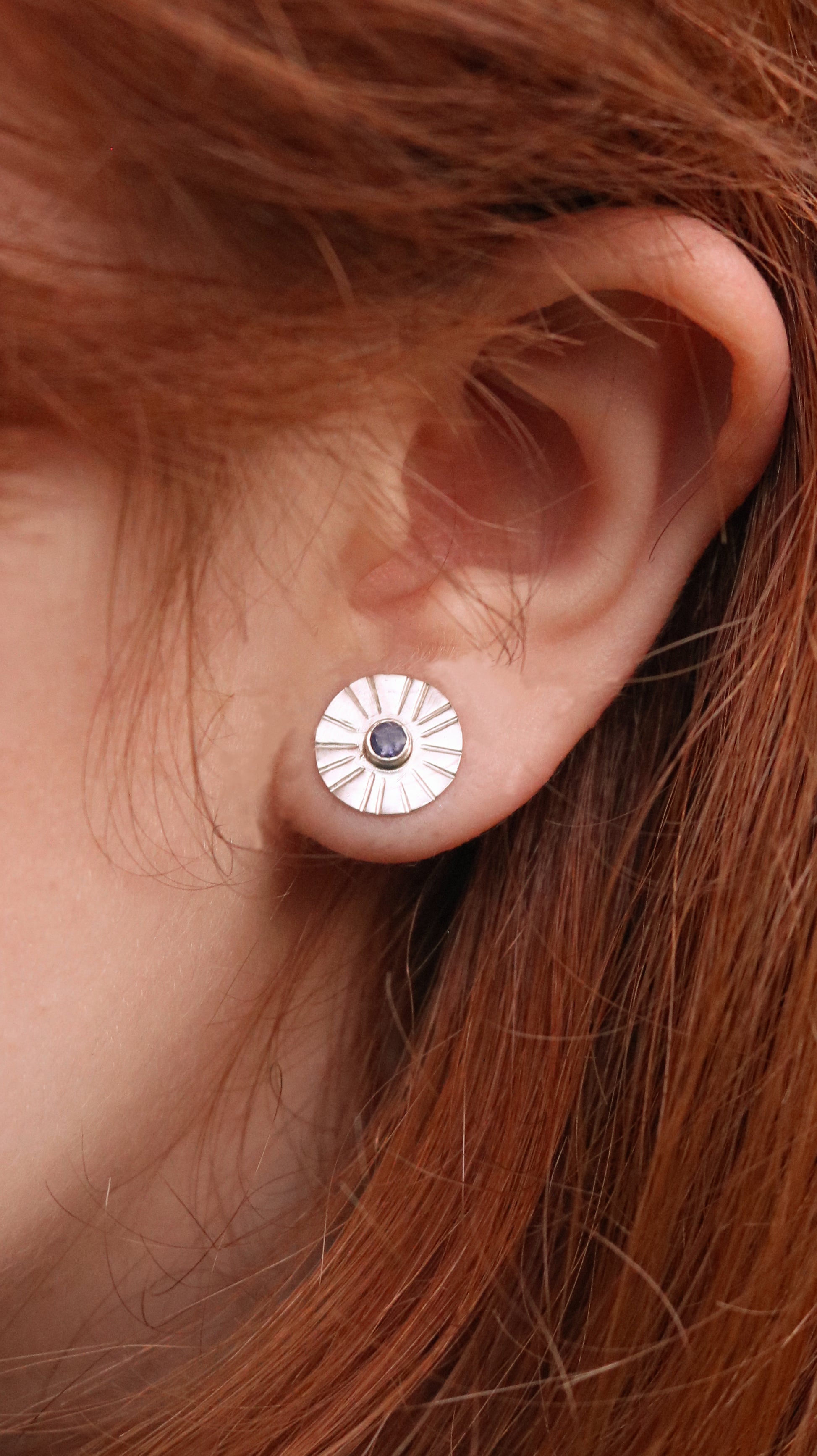 Sterling silver disc stud earrings with a natural round gemstone that has sunburst lines.