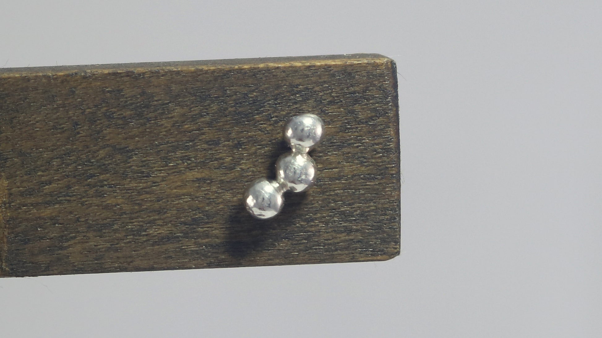 Sterling silver studs with three bubbles along a curve.