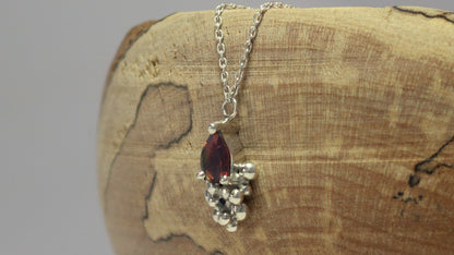 Pear shaped natural gemstone prong set in sterling silver with tumble bubble accent on a sterling silver chain.