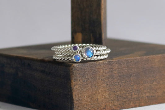 Round natural gemstone set in a sterling silver bezel on a twisted sterling silver ring band.