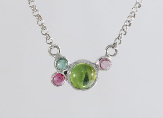Round natural peridot & tourmaline gemstones set in  sterling silver in a cluster on a sterling silver chain.