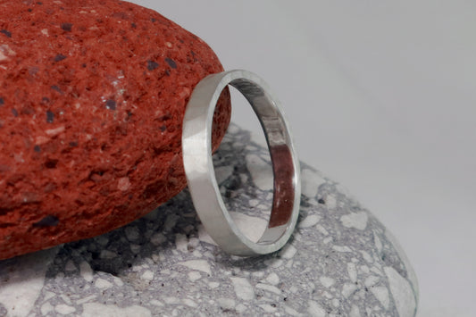 A 4mm silver ring band with a soft hammer texture.
