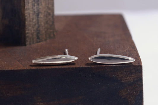 Studs made from solid sterling silver, shaped like a pointed ellipse.