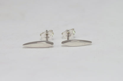 Studs made from solid sterling silver, shaped like a pointed ellipse.