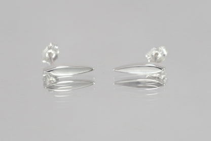 Studs made from solid sterling silver, shaped like a pointed ellipse.