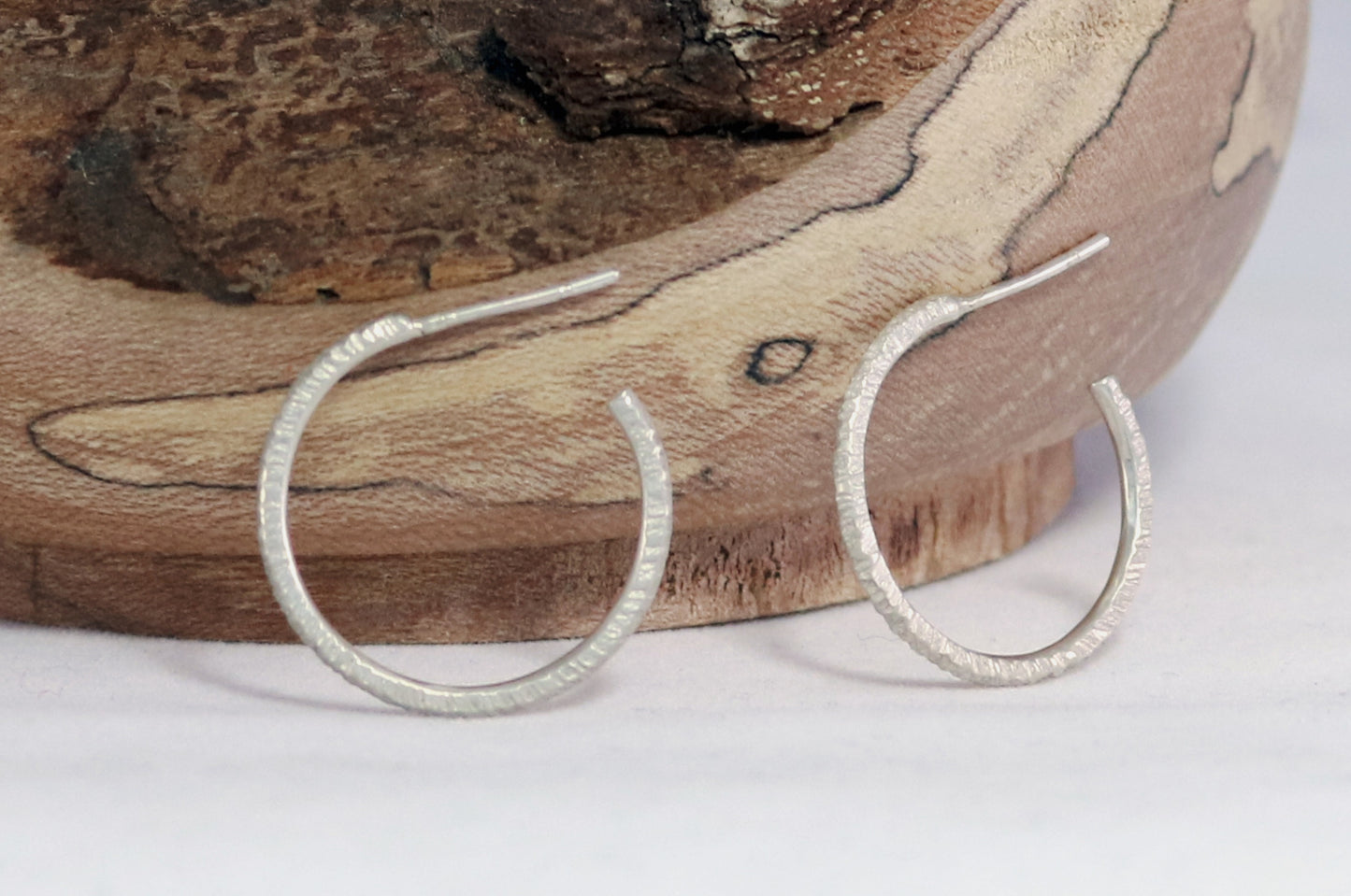 1 inch sterling silver hoops with a rough hammer texture.