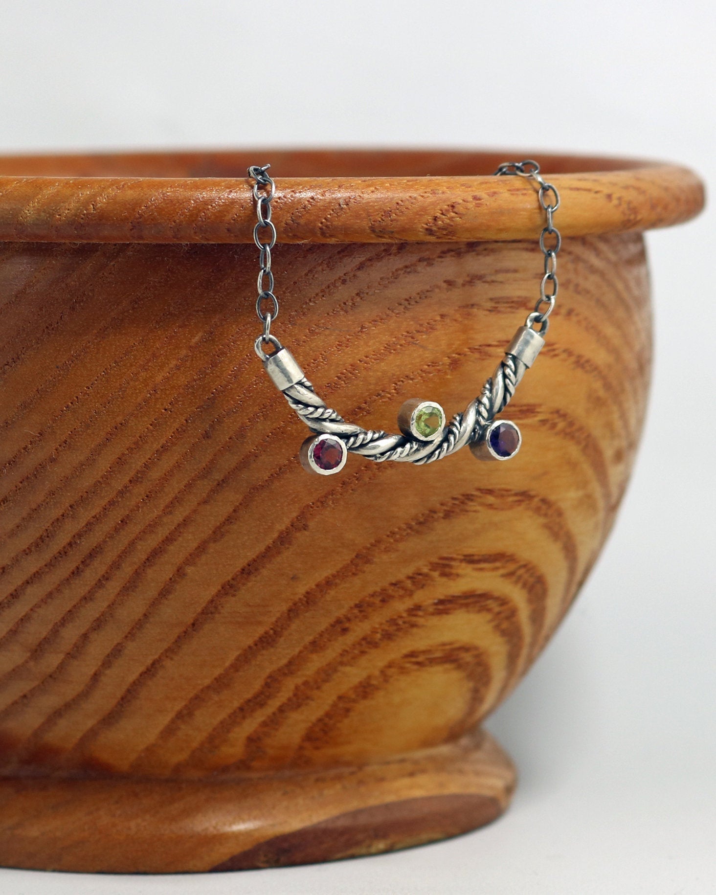 Curved solid sterling silver twisted pendant with 3 bezel set gemstones