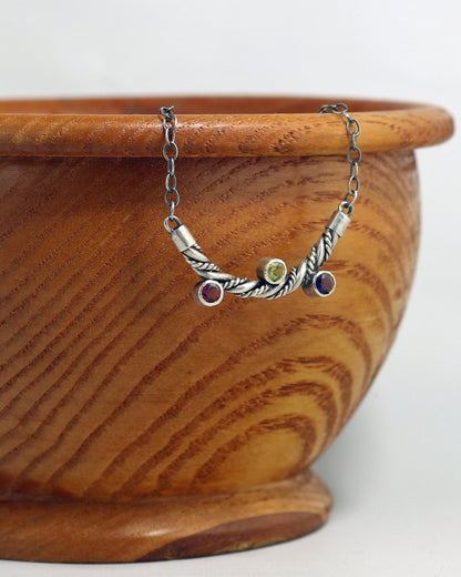 Curved solid sterling silver twisted pendant with 3 bezel set gemstones