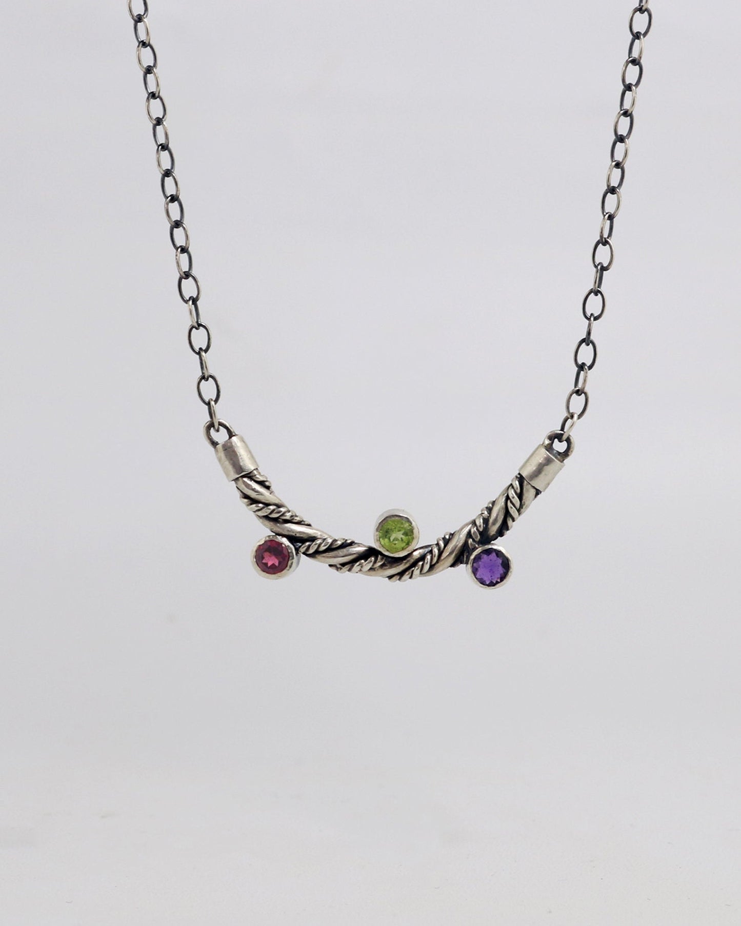 Curved solid sterling silver twisted pendant with 3 bezel set gemstones