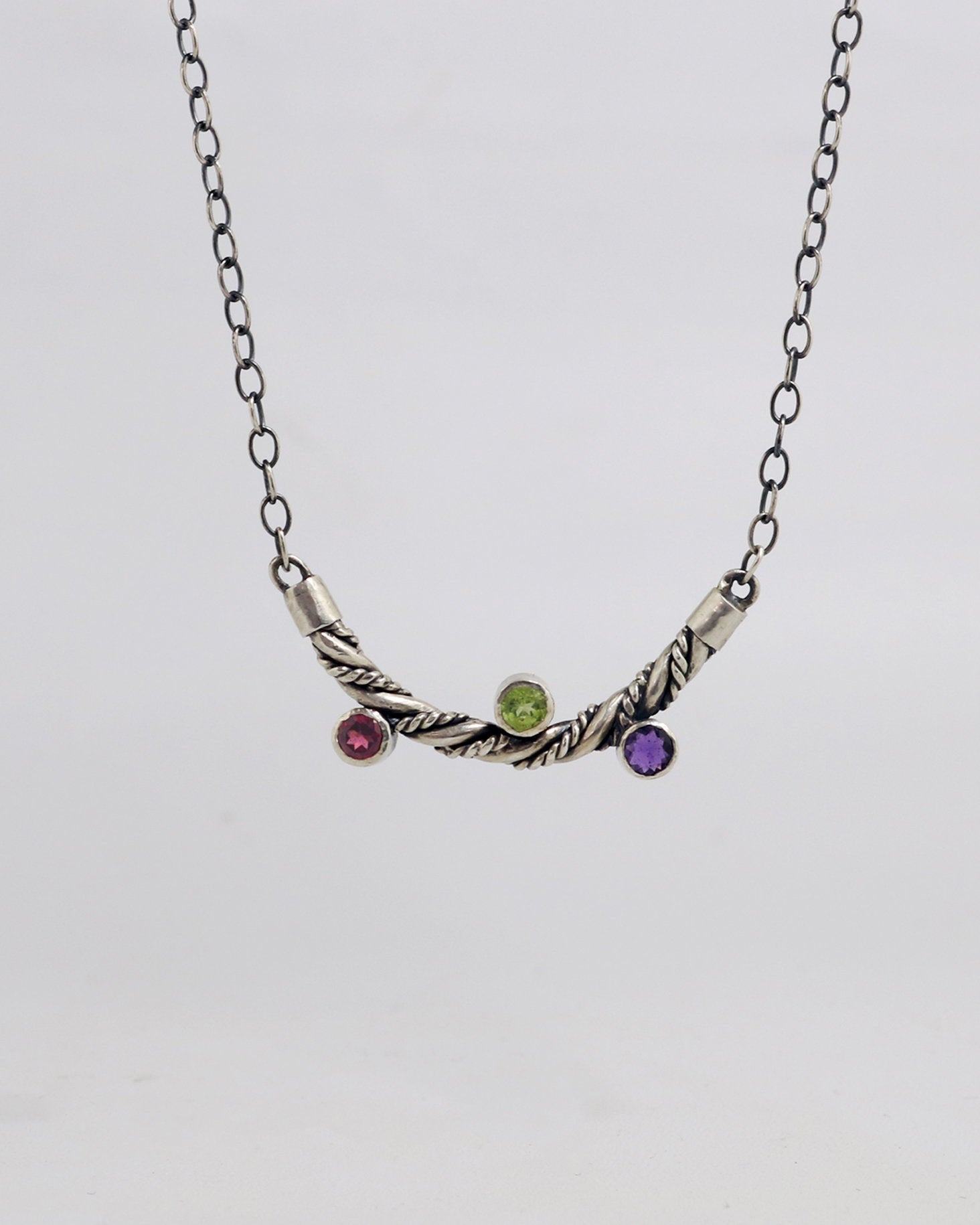 Curved solid sterling silver twisted pendant with 3 bezel set gemstones
