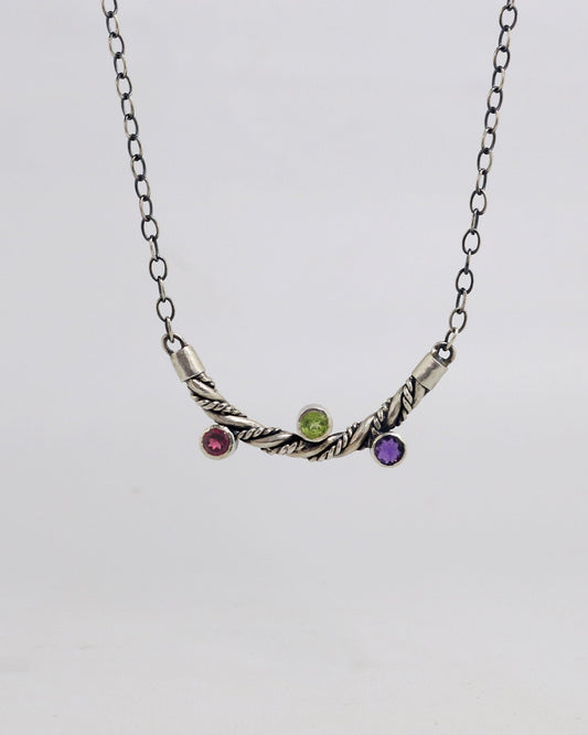 Curved solid sterling silver twisted pendant with 3 bezel set gemstones