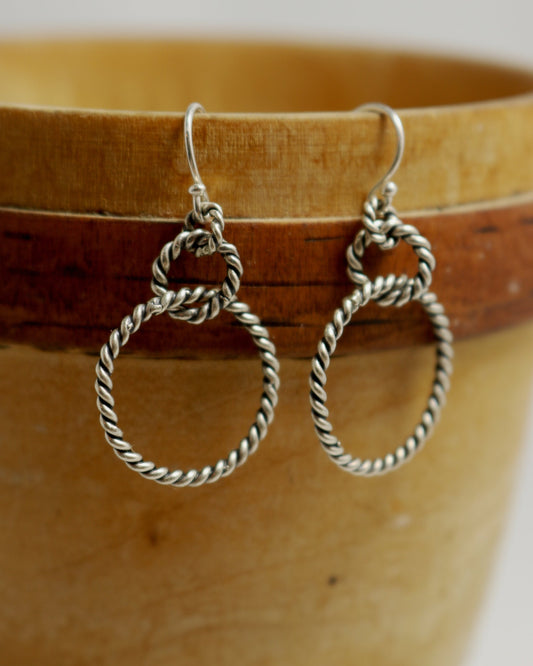 Sterling silver dangle earrings made from interlocked twisted silver circles.