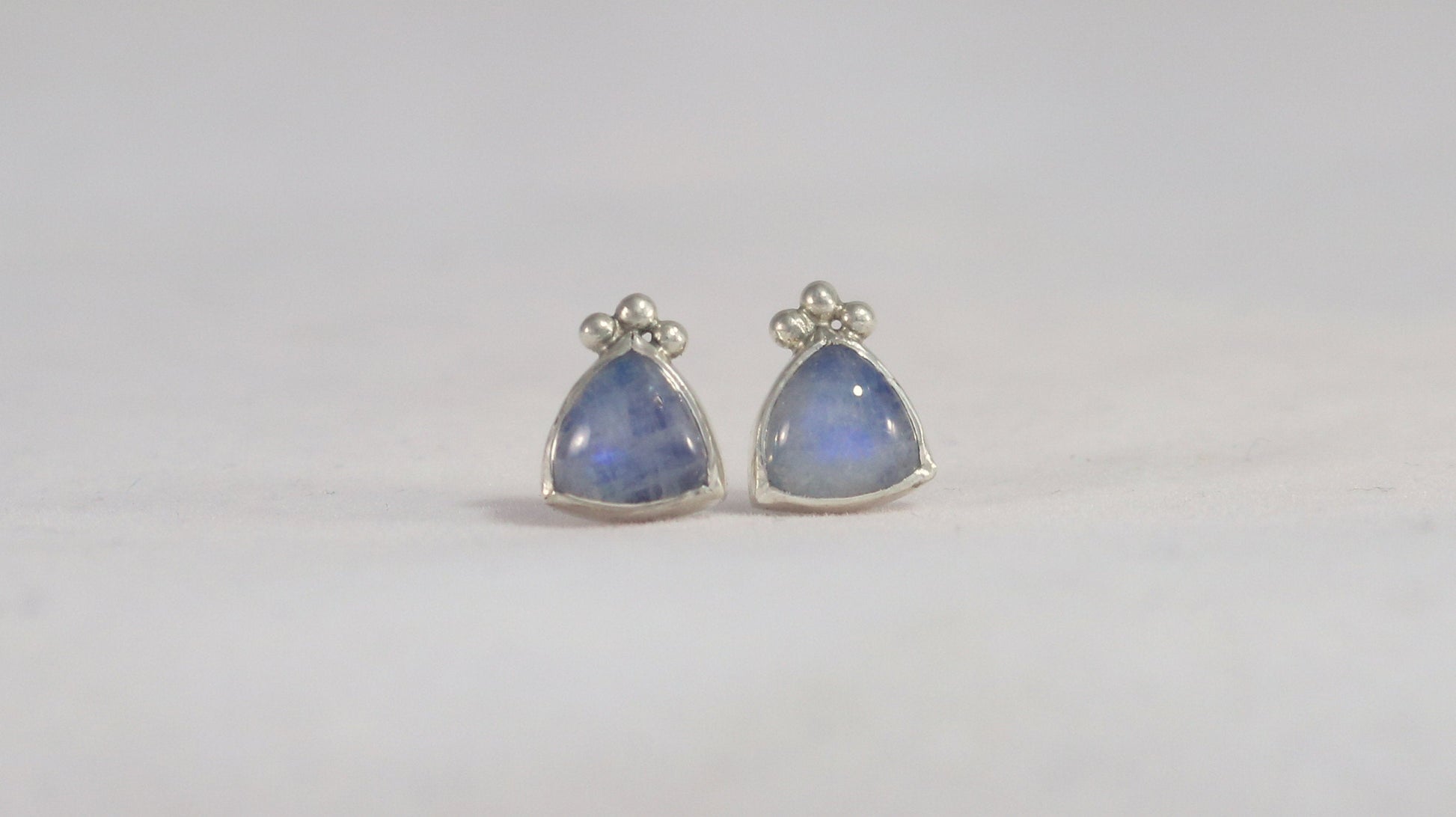 Natural trillion gemstones set in sterling silver bezel with 3 silver bubble accents, stud earrings.