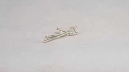 Sterling silver long bar studs with linear texture.