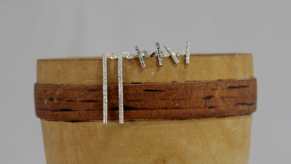 Sterling silver long bar studs with linear texture.